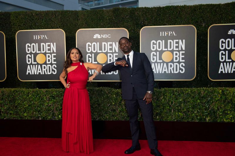 This handout photo courtesy of the HFPA shows Salma Hayek and Sterling K. Brown elbow bump at the Golden Globes