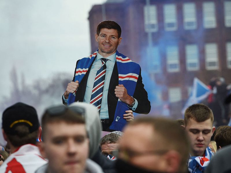 Fans hold aloft a live-size cut-out of Steven Gerrard after Rangers won the Scottish Premiership title