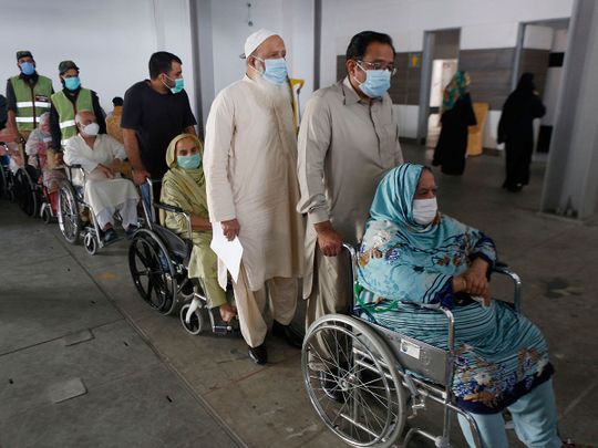 Lahore: Senior citizens wait their turn to receive the Sinopharm coronavirus vaccine from a health worker at a vaccination center, in Lahore, Pakistan, 