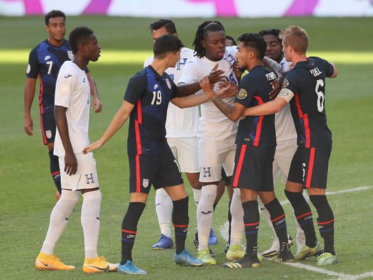 Honduras' Jose Garcia and United States' Jesus Ferreira argue during the Olympic qualifier