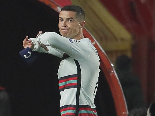Portugal's Cristiano Ronaldo throws away his armband against Serbia