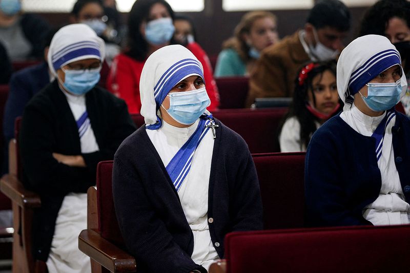 Missionary Sisters of Mother Teresa join Palestinian Christians attending an Easter mass at the Roman Catholic church of the Holy Family in Gaza City.