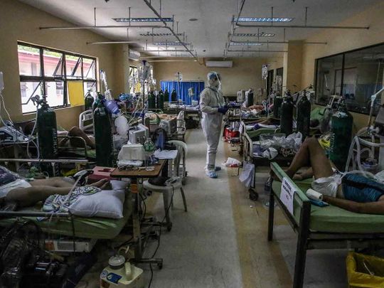 This handout photo taken on April 6, 2021 by a health worker for AFP, courtesy of the Dr. Jose N. Rodriguez Memorial Hospital and Sanitarium, shows a general view of COVID-19 patients and medical workers at a ward in the hospital in Manila.