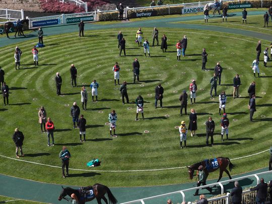 Jockeys and trainers stand for a minute's silence to mark the passing of Prince Philip, Duke of Edinburgh