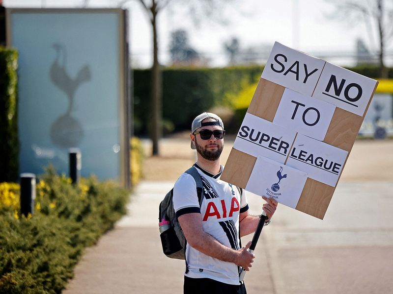 A Spurs fan holds up a placard protesting the Super League. Tottenham are one of the six English clubs to commit to the ESL.