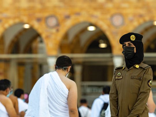 A female soldier stands guard at the Grand Mosque in Mecca.