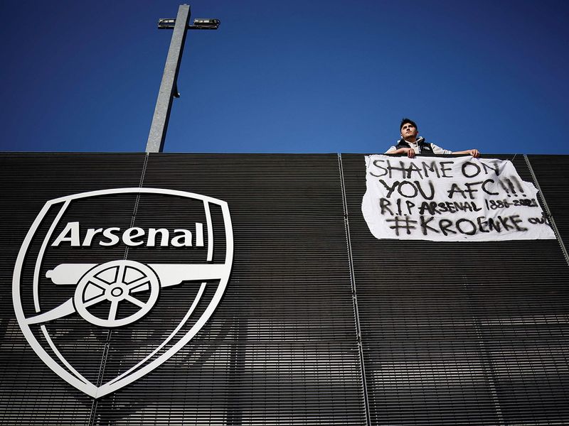 An Arsenal fan stands with his anti-European Super League banner outside the Emirates Stadium, home of English Premier League football club Arsenal.