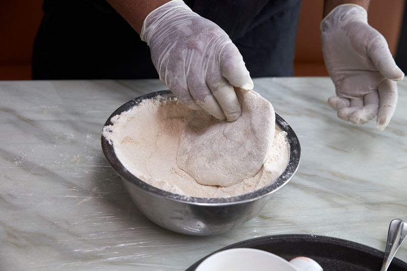 Flatten the dough in your hand and cover with flour