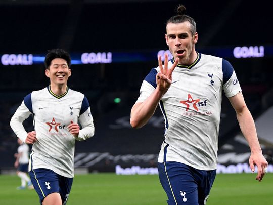 Gareth Bale celebrates hat trick for Tottenham Hotspur with teammate Son Heung-min.