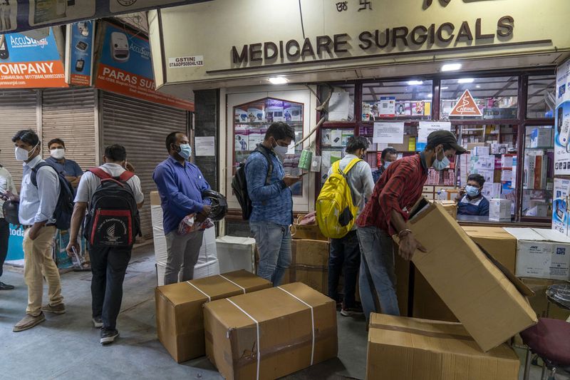 Customers line up at a store at the Bhagirath Palace wholesale medicine market in New Delhi, India, on Wednesday, May 5, 2021. The coronavirus wave that plunged India into the world's biggest health crisis has the potential to worsen in the coming weeks, with some research models projecting that the death toll could more than double from current levels.