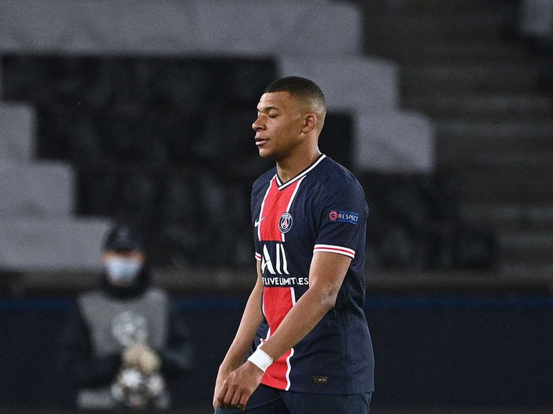 PSG's Kylian Mbappe looks dejected as Manchester City celebrate their Champions League win.