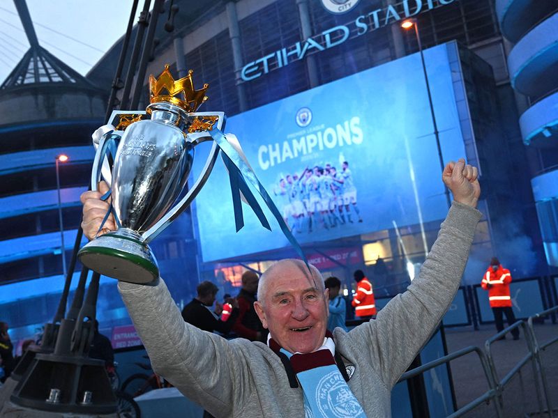 Manchester City fans celebrate winning the English Premier League title