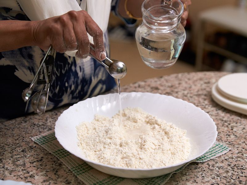 Adding water to knead - Guide to making Luchi 