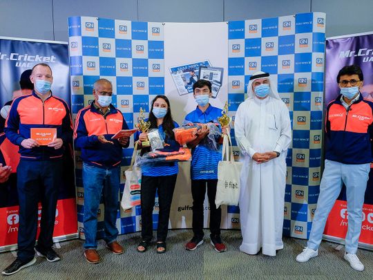 Mr Cricket UAE Anis Sajan and Abdul Hamid, CEO, EIC & Executive Director Publications, accompanied by Gulf News staff Shyam A. Krishna, Senior Associate Editor, and Matthew Smith, Sports Editor, present the trophy along with other gifts to the winners Maaz Ahmed and Heta Khan from Delhi Capitals, after the IPL 2021 Quiz by Gulf News and Mr Cricket UAE in Dubai