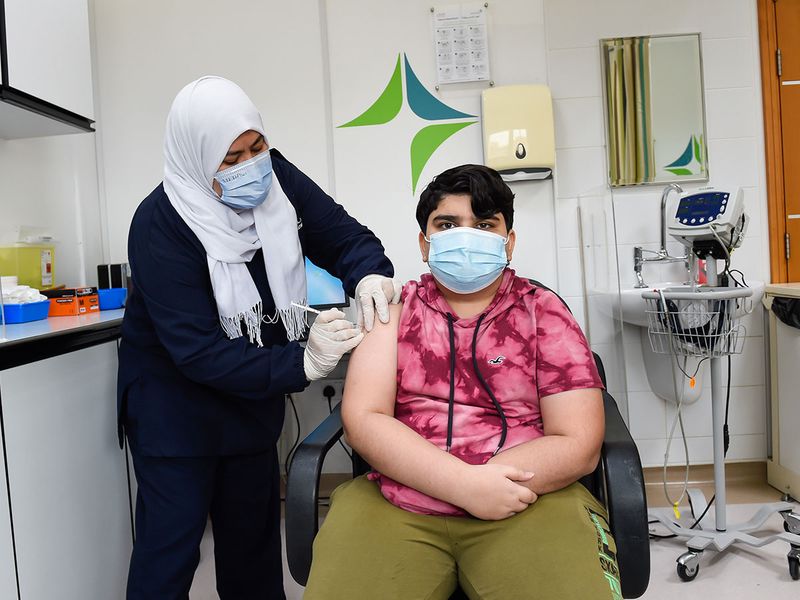 Daksh Joshi, 13 years old Dubai resident getting his first dose of  Pfizer-BioNTech Covid vaccine at Dubai Health Authority's Al Mizhar Health Center