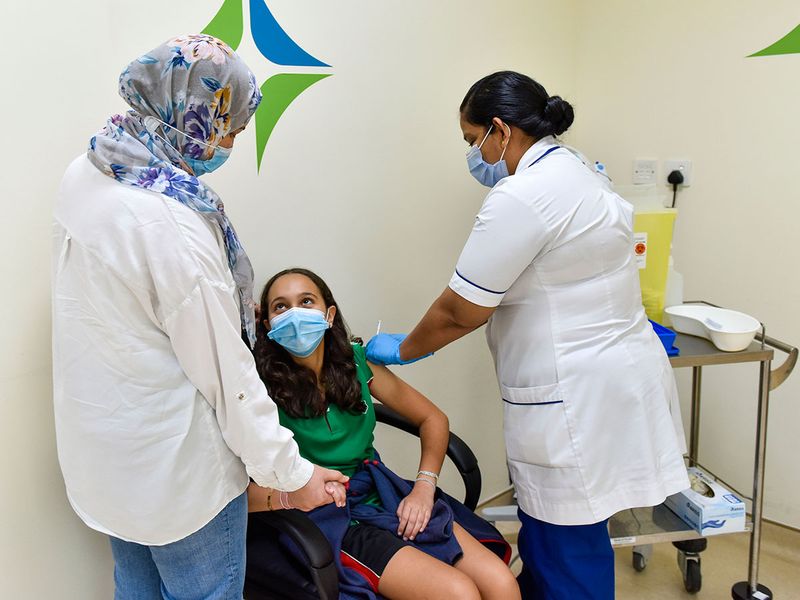Reem Hilili gets vaccinated against COVID-19 at Al Barsha Health Centre in Dubai. 