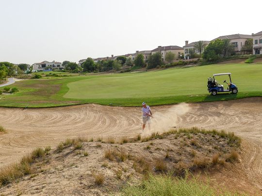 Mark Rix of English Roses plays a bunker shot at the EAGL Mini-Series on the Fire Course at Jumeirah Golf Estates