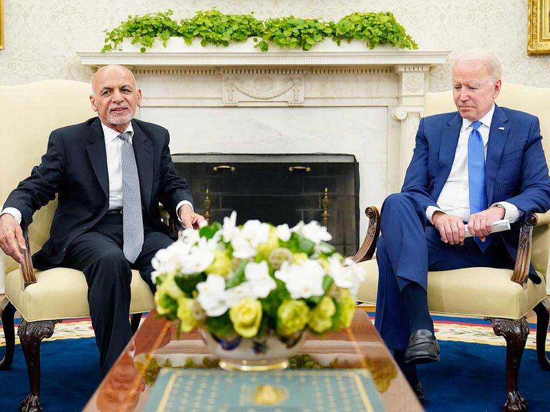 President Joe Biden, right, listens as Afghan President Ashraf Ghani