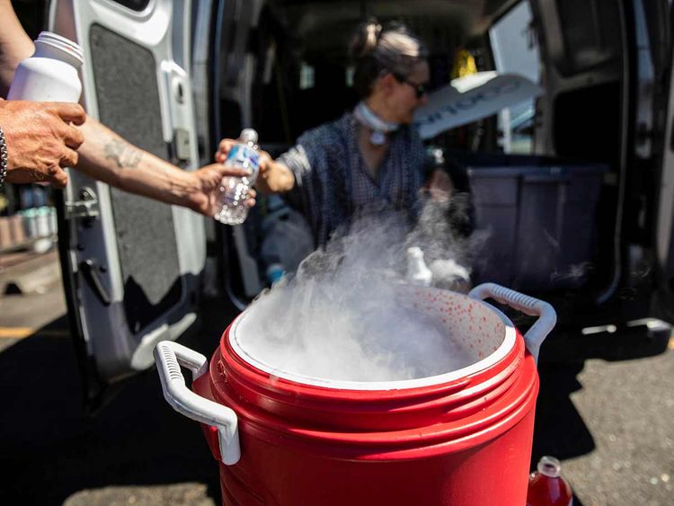 People use dry ice to cool water and Gatorade due to an ice shortage during an unprecedented heat wave in Portland, Oregon. 