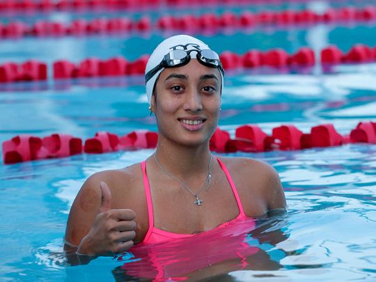 Indian swimmer Maana Patel who has qualified for the women's 100m backstroke at the Tokyo Olympics gestures to camera during her practice in Ahmedabad, India, Sunday, July 4, 2021. 