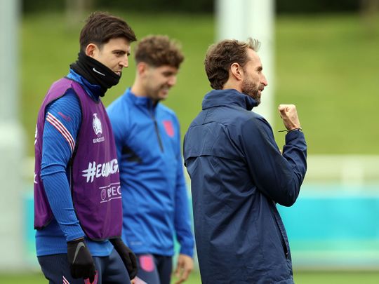 England manager Gareth Southgate with Harry Maguire and John Stones during training 