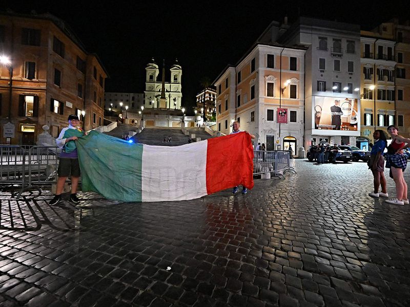 Supporters of Italy's national football team celebrate defeating Spain