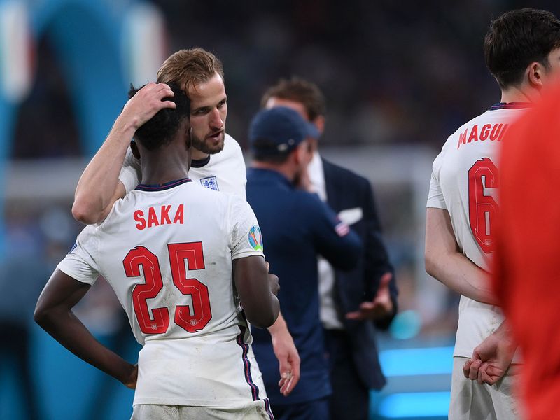 England's Harry Kane consoles Bukayo Saka after the penalty shootout against Italy in the Euro 2020 final