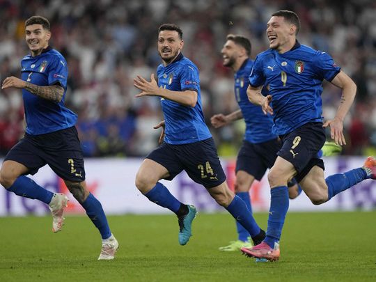 Italy players celebrate the penalty shootout win over England