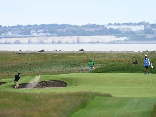 Rory McIlroy plays out of a green-side bunker during a practice round for The Open 