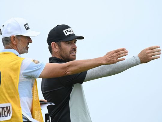 South Africa's Louis Oosthuizen speaks with caddie Colin Byrne during his first round The 149th British Open 