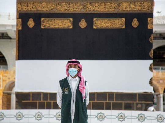 An official from Hajj Ministry wearing a face mask stands in front of the Holy Kaaba in the Grand Mosque during the annual Haj pilgrimage, in the holy city of Mecca, Saudi Arabia, 