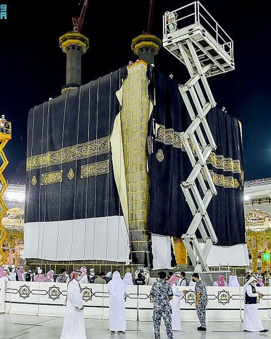 Officials replace the new covering cloth of the holy Kaaba (Kiswa) during the annual Haj pilgrimage, in the holy city of Mecca.  
