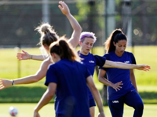 Megan Rapinoe, second right, and her Olympic football teammates warm up at a training session 