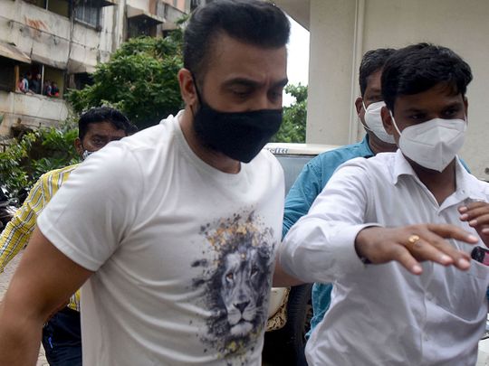 Police escort arrested Bollywood star Shilpa Shetty's husband Raj Kundra (L) for allegedly producing and broadcasting pornographic films online, in Mumbai on July 20, 2021. 