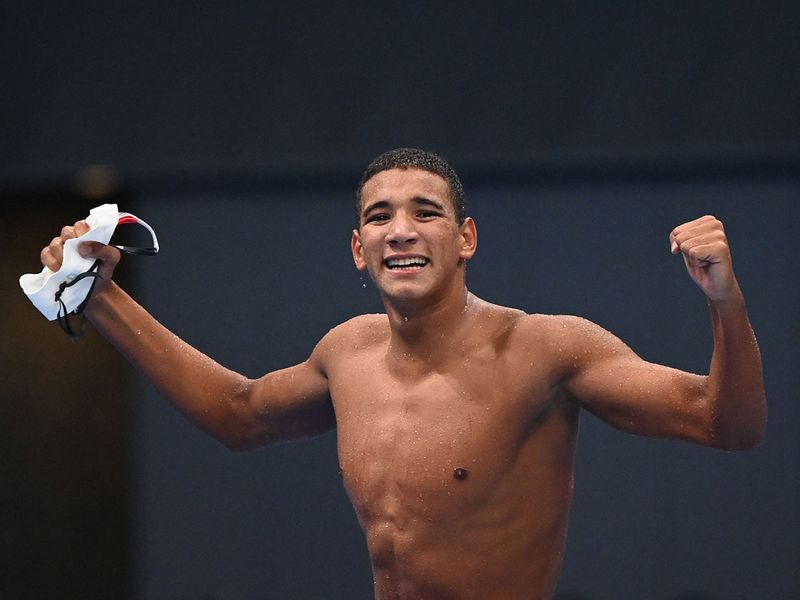 Tunisia's Ahmed Hafnaoui celebrates after winning the men's 400m freestyle gold