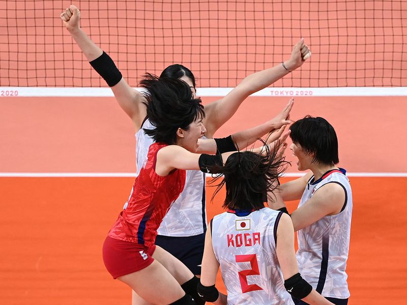 Japan celebrate a point against Sourth Korea in their volleyball clash