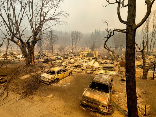 This photo shows cars and homes destroyed by the Dixie Fire line central Greenville, in Plumas County, California. 