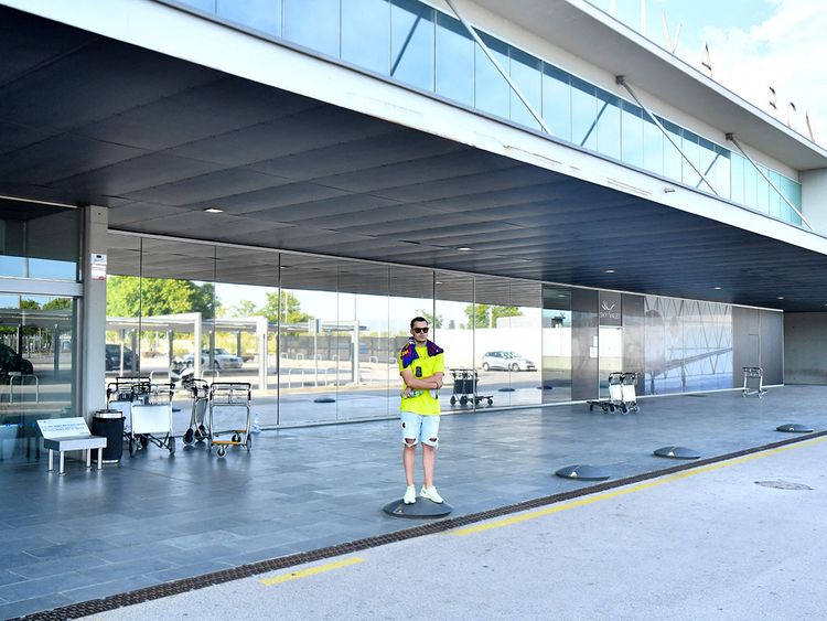 A lone Barcelona fan outside the city's airport as Lionel Messi heads to Paris