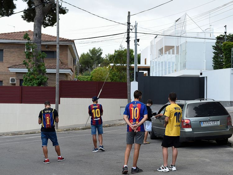 Fans wait in vain for an appearance of Lionel Messi outside his house in Barcelona