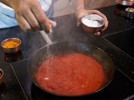 Add salt to the tomato gravy 