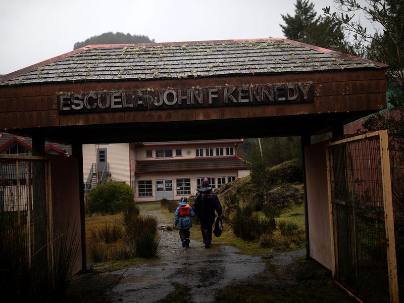 Carlos Guerrero, 40, with his son Diego, 7, arrive at John F Kennedy School in the village of Sotomo, outside the town of Cochamo, Los Lagos region, Chile