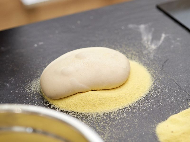 Place the dough on semolina 