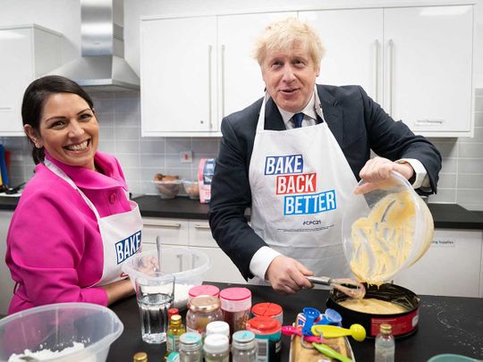Britain's Home Secretary Priti Patel (L) and Britain's Prime Minister Boris Johnson 
