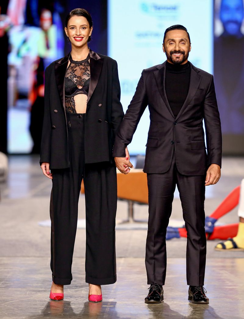 Bollywood actors Rahul Bose and Tripti Dimri walk on the ramp to present the creations by designers Satya Paul and Rajesh Pratap Singh during the ‘FDCI x Lakme Fashion Week’ fashion show, in Mumbai, Friday, October 8, 2021
