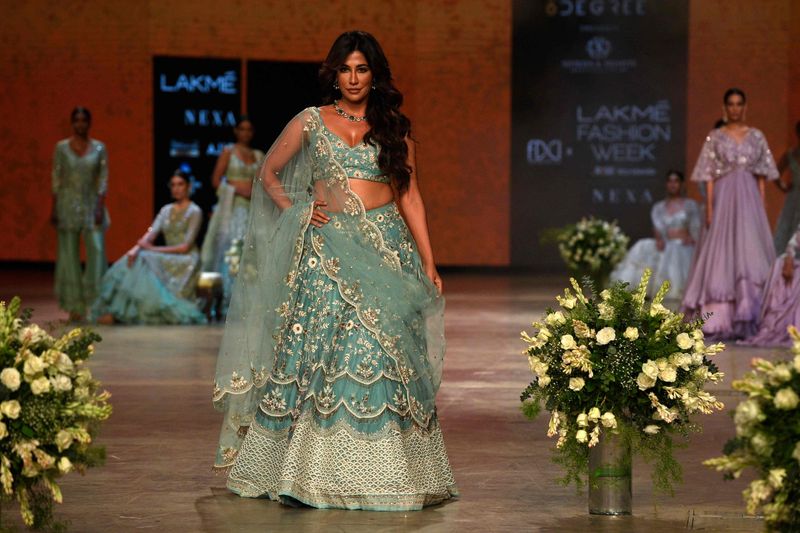 Bollywood actress Chitrangada Singh (C) presents a creations by designer Shikha and Srishti during the ‘FDCI x Lakme Fashion Week’ fashion show in Mumbai on October 10, 2021