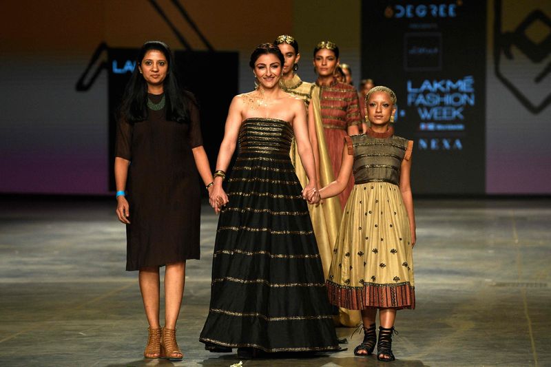 Bollywood actress Soha Ali Khan (centre) and models present creations by designer Megha Jain Madaan during the ‘FDCI x Lakme Fashion Week’ fashion show in Mumbai on October 10, 2021