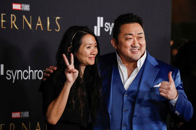 Cast member Ma Dong-seok, also known as Don Lee, poses with director Chloe Zhao at the premiere for the film 