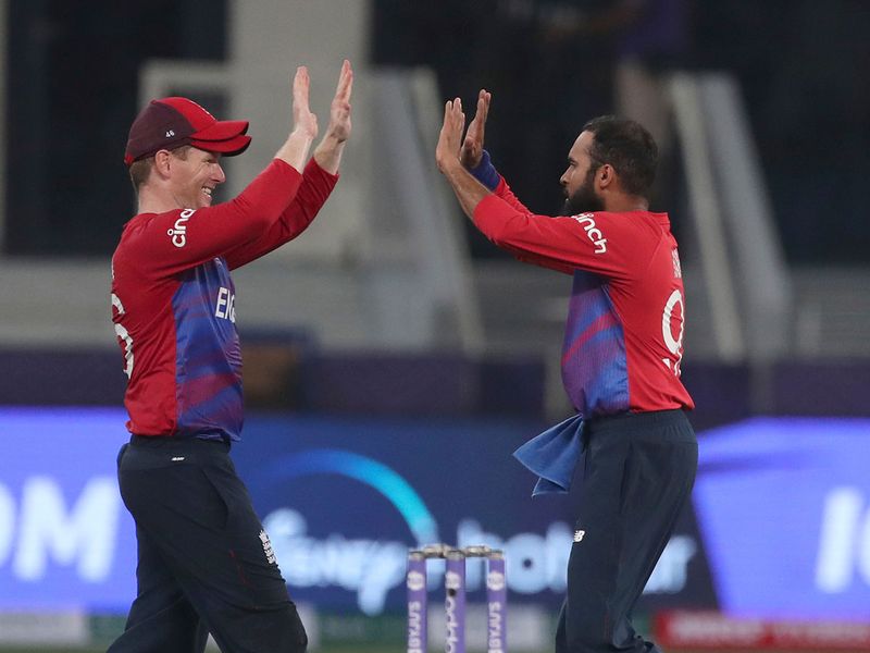 England's Adil Rashid and Eoin Morgan celebrate  the departure of West Indies' captain Kieron Pollard 