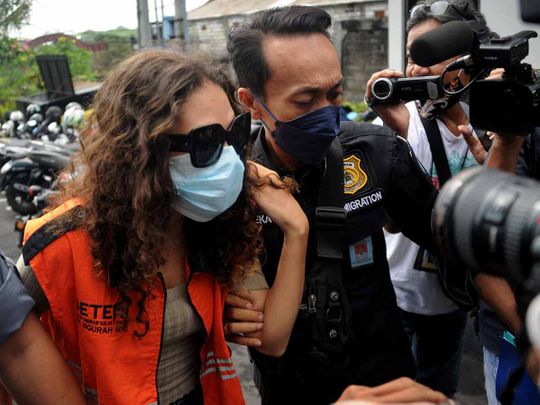 Heather Mack (C) of the US is escorted by Immigration guards to the immigration detention house in Jimbaran, on the resort island of Bali on October 29, 2021.