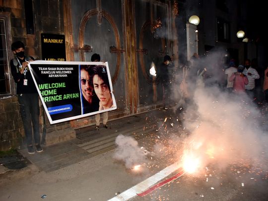 Bollywood actor Shah Rukh Khan fans celebrate outside his residence 'Mannat' after Bombay High Court granted bail to his son Aryan Khan in the drugs-on-cruise case
